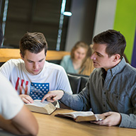 college student mentoring a teenager - studying the bible